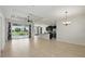 An open-concept living room and kitchen featuring tile flooring, recessed lighting, and access to the outdoor pool area at 7505 Carissa, Punta Gorda, FL 33955