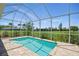 Screened-in pool area with brick pavers and view of the expansive, well-maintained yard at 7505 Carissa, Punta Gorda, FL 33955