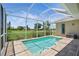 Screened-in pool area with brick pavers and view of the expansive, well-maintained yard at 7505 Carissa, Punta Gorda, FL 33955