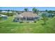 Rear exterior of home with screened-in pool, lush landscaping, well-maintained lawn, and inviting outdoor space at 7505 Carissa, Punta Gorda, FL 33955