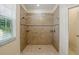 Tiled shower with built-in shelves, a shower curtain rod, and natural light from the window at 7505 Carissa, Punta Gorda, FL 33955