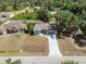 Aerial front view of the home showcasing its long driveway and landscaping at 8849 Attalla Ave, North Port, FL 34287