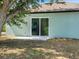 The backyard has a concrete patio, and a large sliding glass door at 8849 Attalla Ave, North Port, FL 34287