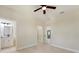 Bright bedroom with a ceiling fan and an adjacent bathroom and a doorway at 8849 Attalla Ave, North Port, FL 34287