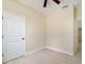 This bedroom includes neutral walls, light-colored flooring, and a white door at 8849 Attalla Ave, North Port, FL 34287
