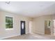 Bright entryway featuring a decorative front door, neutral paint, and wood-look tile flooring at 8849 Attalla Ave, North Port, FL 34287