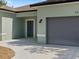 Exterior shot featuring a garage and the front door entrance at 8849 Attalla Ave, North Port, FL 34287