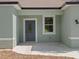 Close-up of the front entrance with a gray door and a small window at 8849 Attalla Ave, North Port, FL 34287