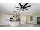 Open kitchen with pendant lights, stainless appliances, and ceiling fan adjacent to a door at 8849 Attalla Ave, North Port, FL 34287