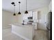 Modern kitchen with stainless appliances, an island with marble countertop, and pendant lights at 8849 Attalla Ave, North Port, FL 34287
