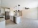 Spacious kitchen featuring stainless appliances, marble countertops, and an island with pendant lights at 8849 Attalla Ave, North Port, FL 34287