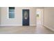 View of the living room, with light-colored floors and walls and a decorative front door at 8849 Attalla Ave, North Port, FL 34287