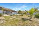 Lush backyard featuring an above-ground pool, covered patio, and tropical landscaping for private outdoor enjoyment at 9295 Melody Cir, Port Charlotte, FL 33981