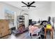Bedroom with large window, ceiling fan, laminate floors, and neutral walls at 9295 Melody Cir, Port Charlotte, FL 33981