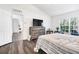 Bedroom features a TV and a natural light filled window at 9295 Melody Cir, Port Charlotte, FL 33981
