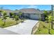 Beautiful single-Gathering home with a spacious driveway, well-maintained lawn, and inviting curb appeal at 9295 Melody Cir, Port Charlotte, FL 33981