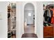 Hallway with archway with wood floors and access to closets at 9295 Melody Cir, Port Charlotte, FL 33981