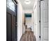 Hallway with hardwood floors and access to the bathroom and front door at 9295 Melody Cir, Port Charlotte, FL 33981