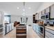 Bright kitchen features stainless appliances, center island with sink, and tile flooring at 9295 Melody Cir, Port Charlotte, FL 33981