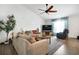 Cozy living room with plush furniture, a ceiling fan, and large windows for natural light at 9295 Melody Cir, Port Charlotte, FL 33981