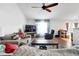 Spacious living room with comfortable seating, a ceiling fan, and hardwood floors at 9295 Melody Cir, Port Charlotte, FL 33981