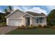 Charming single-story home with a two-car garage, manicured lawn, and beautiful landscaping at 9474 Turtle Grass Cir, Punta Gorda, FL 33950