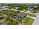 The aerial view reveals a home with a screened pool, surrounded by canals and dense vegetation in a residential area at 10233 St Paul Dr, Port Charlotte, FL 33981