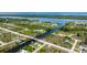 Scenic aerial view of the neighborhood with a canal system and scattered residential properties at 10233 St Paul Dr, Port Charlotte, FL 33981