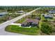 The aerial view showcases a single-story home with lush lawn, mature landscaping and a long driveway at 10233 St Paul Dr, Port Charlotte, FL 33981