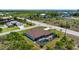 Aerial view reveals a home with a screened pool, adjacent to canals and lush vegetation in a residential area at 10233 St Paul Dr, Port Charlotte, FL 33981