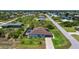 Aerial view of single-story home with screened pool, set in a neighborhood with canals and lush vegetation at 10233 St Paul Dr, Port Charlotte, FL 33981