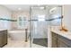 Luxurious bathroom with a soaking tub, walk-in shower, and marble tile, creating a spa-like retreat at 10233 St Paul Dr, Port Charlotte, FL 33981