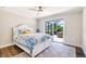 Comfortable bedroom with patio access, ceiling fan, and decorative bedding at 10233 St Paul Dr, Port Charlotte, FL 33981