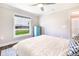 A bright bedroom with a great outdoor view, and a charming blue dresser at 10233 St Paul Dr, Port Charlotte, FL 33981