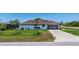 A well-maintained home featuring a brick driveway and an attached garage with lush landscaping at 10233 St Paul Dr, Port Charlotte, FL 33981