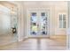 Grand foyer featuring beautiful wood flooring and views into the dining room and front yard at 10233 St Paul Dr, Port Charlotte, FL 33981