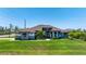 Beautiful single-story home featuring a well-manicured lawn, tasteful landscaping and a symmetrical facade at 10233 St Paul Dr, Port Charlotte, FL 33981