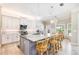 Well-lit kitchen with large island, breakfast bar and white cabinetry at 10233 St Paul Dr, Port Charlotte, FL 33981