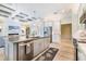 Bright open kitchen featuring modern appliances, granite countertops and an island with views of the living area at 10233 St Paul Dr, Port Charlotte, FL 33981