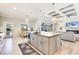Bright, open kitchen with a large island, stainless steel appliances, and adjacent dining area with backyard access at 10233 St Paul Dr, Port Charlotte, FL 33981
