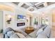Stylish living room with modern fireplace, TV and large sectional sofa at 10233 St Paul Dr, Port Charlotte, FL 33981