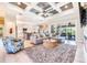 Open-concept living room with modern décor, large sectional, and view of the kitchen at 10233 St Paul Dr, Port Charlotte, FL 33981