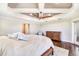 A serene main bedroom featuring dark wood floors, tray ceilings, and lots of light at 10233 St Paul Dr, Port Charlotte, FL 33981