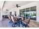 Covered patio features a dining table set beneath a ceiling fan and has sliding glass doors to the interior at 10233 St Paul Dr, Port Charlotte, FL 33981