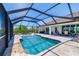 Enclosed pool area with outdoor dining and cooking area creates a great space to entertain at 10233 St Paul Dr, Port Charlotte, FL 33981