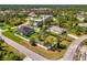 An aerial view shows the property, adjacent lot and the surrounding area at 1321 Calgary Rd, North Port, FL 34288