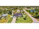 Aerial view of gray home with well manicured lawn and additional lot for sale at 1321 Calgary Rd, North Port, FL 34288