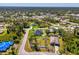 Aerial view of a home with a screened-in pool, large backyard, and adjacent shed at 1321 Calgary Rd, North Port, FL 34288