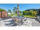 Outdoor patio area with a dining table, seating, and lush landscaping at 1321 Calgary Rd, North Port, FL 34288