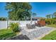 Charming brick patio with dining set, lounge chairs, and a well-maintained lawn at 1321 Calgary Rd, North Port, FL 34288
